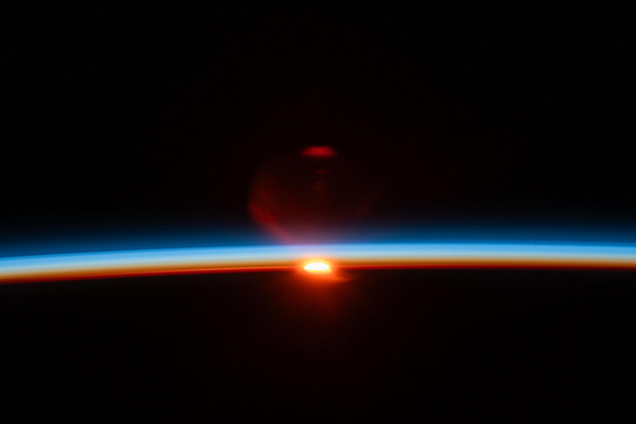 Suns-Last-Rays-Illuminate-Earths-Atmosphere-scaled.jpg