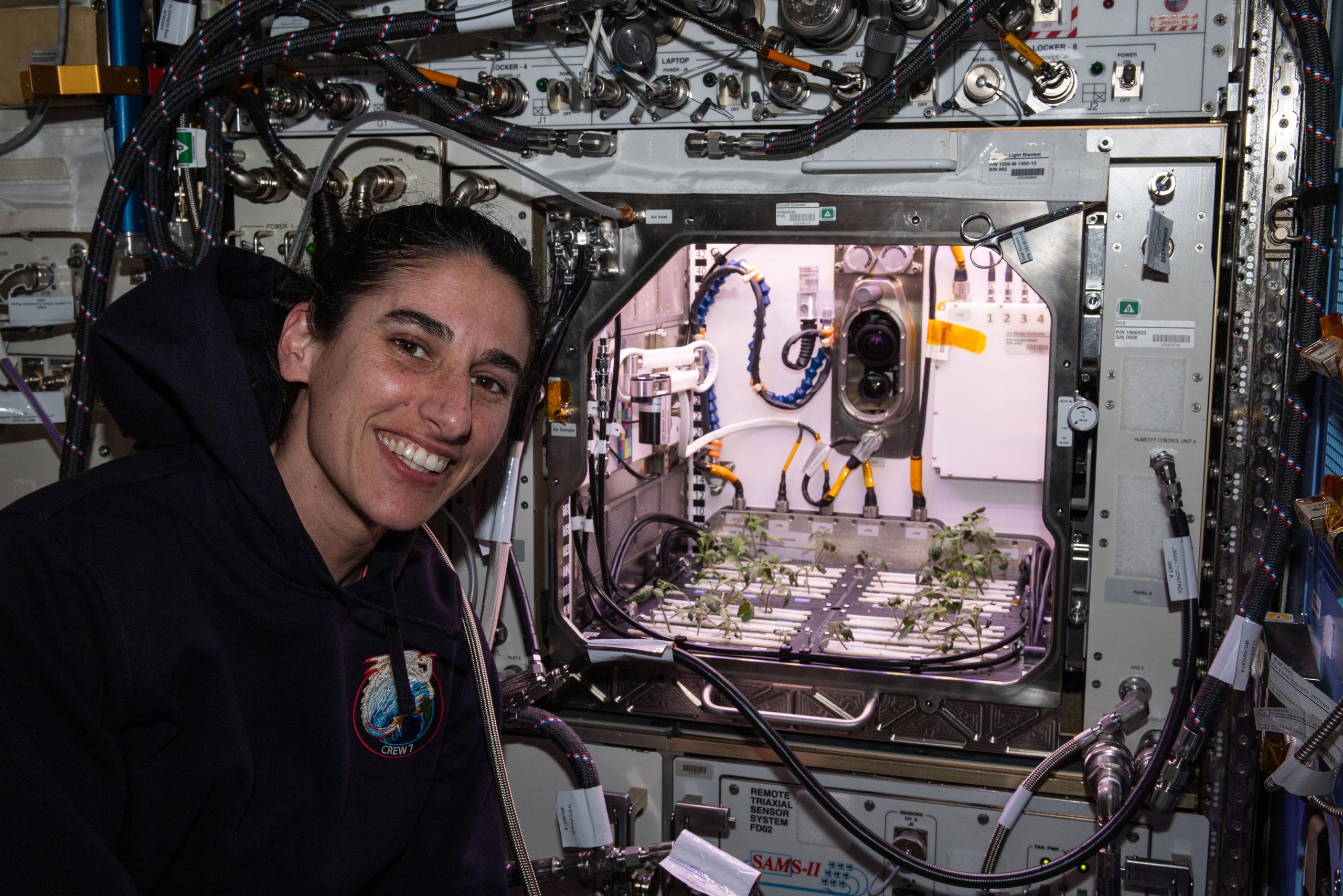 Astronaut-Jasmin-Moghbeli-in-Front-of-Advanced-Plant-Habitat-scaled.jpg